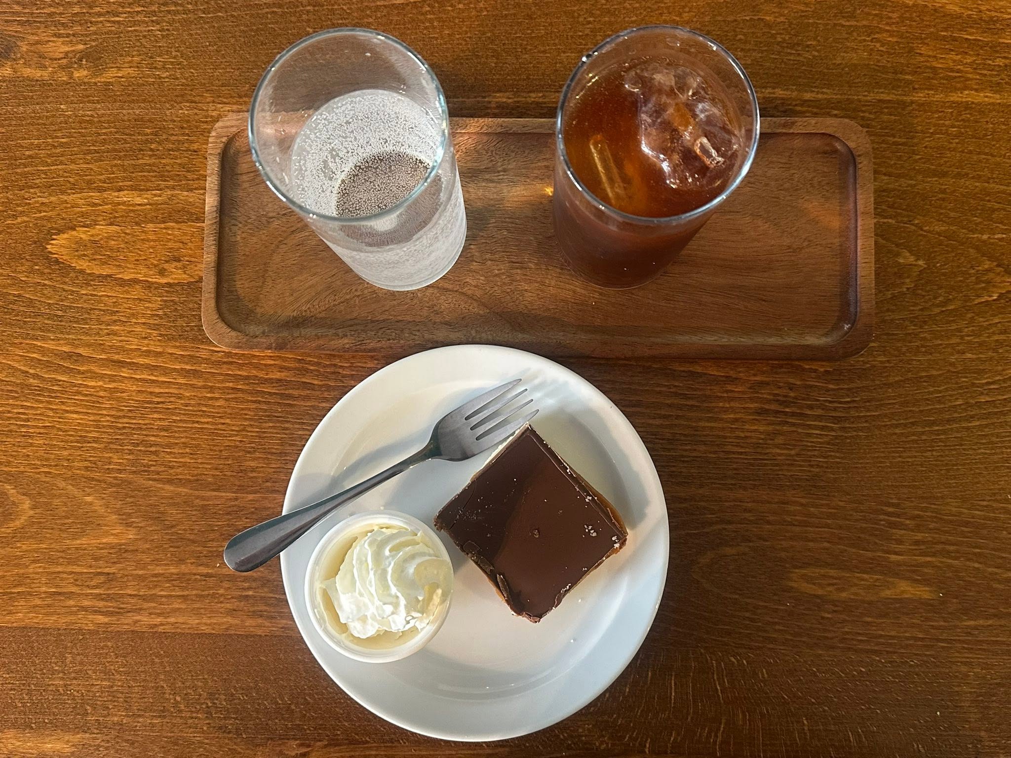 Overhead view of drinks and a slice of cake on the table