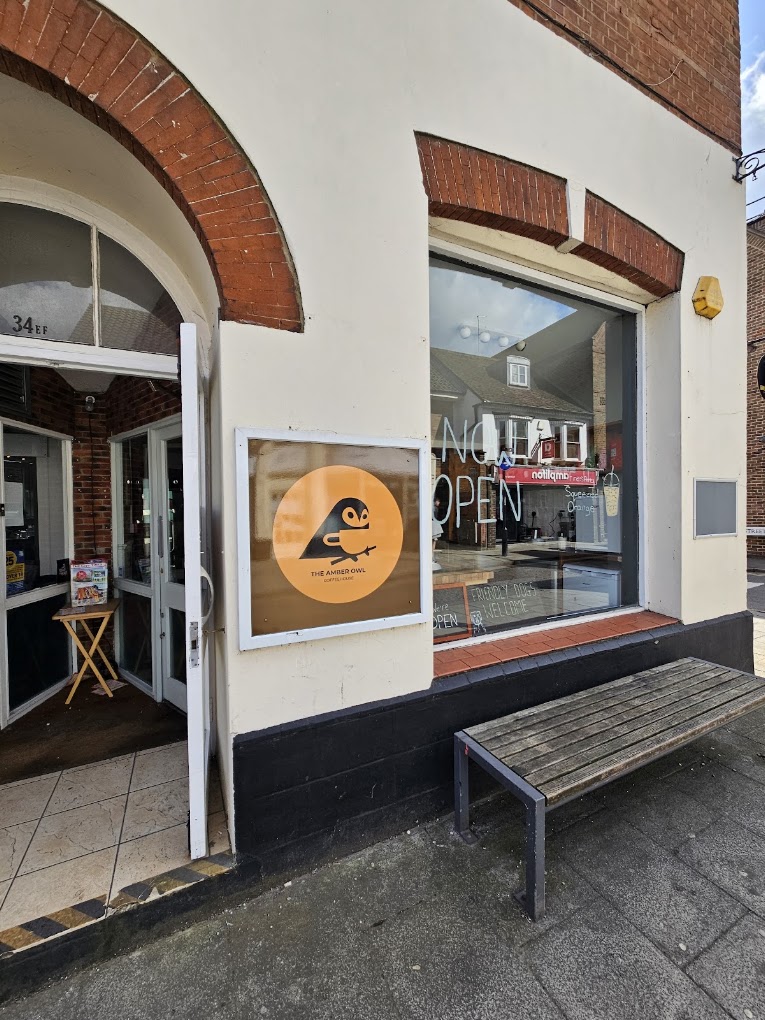 The Amber Owl's shopfront on Moulsham Street, with the owl logo in the window and the door propped open